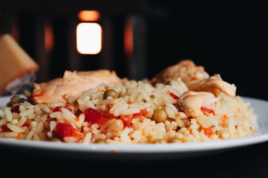 One-pot chicken and rice in a Dutch oven with golden-seared chicken thighs resting on fluffy rice, garnished with fresh parsley