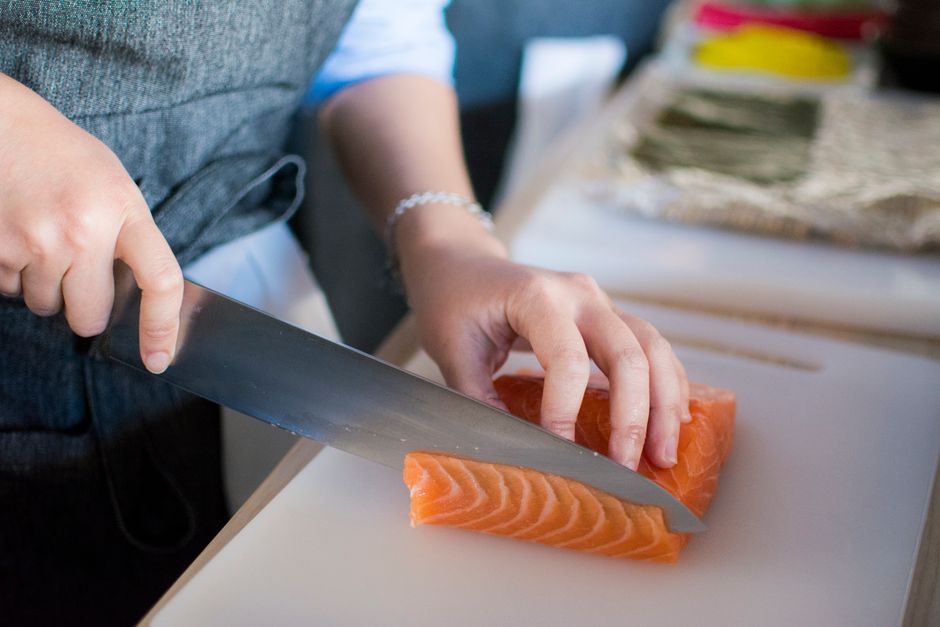 Pan-seared salmon recipe with golden crispy skin and lemon butter sauce in a cast iron skillet, garnished with fresh parsley and lemon slices